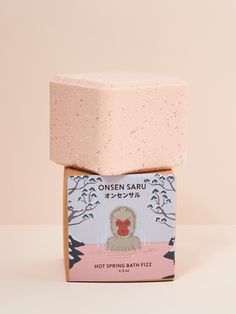 a soap bar sitting on top of a pink box