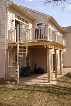 a house with a deck and stairs leading up to it