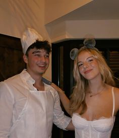 a man and woman dressed up as chefs posing for the camera with one holding a knife