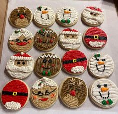 twelve decorated cookies in the shape of santa claus, snowman, and other characters