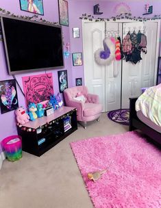 a bedroom decorated in pink and purple with pictures on the wall