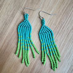 These beaded earrings will bring a pop of color to any outfit. They are hand woven together changing from one color to another. Due to the light weight, this move with your movement (without a tickle). Come in two ombré colors from blue to green and red to orange. Turquoise Handwoven Beaded Earrings With Round Beads, Adjustable Handwoven Green Beaded Earrings, Turquoise Handwoven Round Bead Earrings, Handwoven Turquoise Round Bead Earrings, Dangle Beaded Earrings, Bead Fringe Earrings, Bead Fringe, Teardrop Beads, Earrings Red