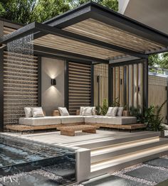 an outdoor living area with couches and water feature