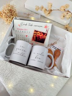 two coffee mugs in a gift box with the date and time printed on them