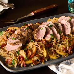 a platter with meat, pasta and vegetables on it