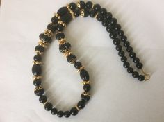 "Trifari TM necklace, made in 1990-s. Black plastic melon beads, round beads, gold beads, gold bead caps necklace Necklace: 30\" Excellent vintage condition." Elegant Black Beads For Festive Occasion, Elegant Black Festive Beads, Gold Onyx Beaded Necklaces With Black Beads, Gold Beaded Necklace With Black Onyx Beads, Gold Onyx Beaded Necklace With Black Beads, Vintage Black Beaded Necklace With Beaded Chain, Vintage Black Beaded Necklace With Large Beads, Traditional Black Single Strand Necklace, Vintage Black Large Beads