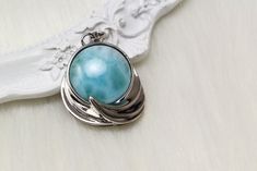 "Material:100% 925 Sterling Silver with White Gold Plated Main stone:Large Larimar Gemstone Other stone:N/A Total Weight:8g Size: 25mm x 25mm / 1 x 1\" Chain: 18\" Silver Chain Condition:New Main color:Blue Quantity:1 Pc This vintage pendant necklace is made with 100% natural genuine rare Larimar stone from Dominican Republic and solid 925 sterling silver w/ Rhodium gold plating for better quality and prolonged shine! *It comes with elegant velvet jewelry gift bag. Please check my other beautifu Larimar Necklace, Vintage Pendant Necklace, Curb Chain Necklace, Minimal Necklace, Larimar Stone, Velvet Jewelry, Vintage Pendant, Aunt Gifts, Curb Chain