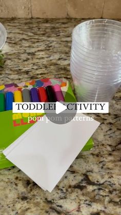 a counter top that has some markers and pens on it with the words toddler activity