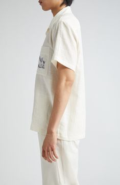 Destined to be a straight-up favorite, this boxy camp shirt cut from breathable cotton is served with a twist thanks to dirty-martini embroidery on the pocket. 31" length; 48" chest (size 50 EU) Front button closure Notched collar Elbow-length sleeves Chest patch pocket 100% cotton Dry clean or machine wash, dry flat Made in Portugal Designer Clothing Embroidered Camp Collar Top With Relaxed Fit, Embroidered Tops With Relaxed Fit And Camp Collar, Embroidered White Short Sleeve Camp Shirt, White Embroidered Short Sleeve Camp Shirt, White Embroidered Cotton Camp Shirt, White Cotton Embroidered Camp Shirt, Embroidered Cotton Camp Collar Tops, Embroidered Cotton Tops With Camp Collar, White Cotton Top With Camp Collar