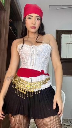 a woman in a white corset and red headband posing for the camera