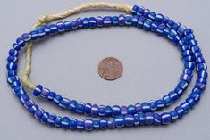 "Vintage Large glass seed beads. These have a matte blue and white color with a denim tone. There is lovely variation of color, shape and size within the strand that you get with the older beads. Wonderful for a more organic tribal feel. 100 beads 24\" of beads - 60cm 8-9mm diameter 2.5-3mm hole" Blue Polished Beads For Beach, Bohemian Blue Heart Beads, Blue Oval Beaded Beads, Ghana Beads, Vintage Blue And White, Maasai, Glass Seed Beads, Pony Beads, Ghana