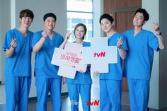 the doctors are holding up a sign that says ntvt in english and chinese