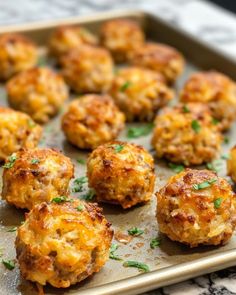 some food is sitting on a baking sheet and ready to be cooked in the oven