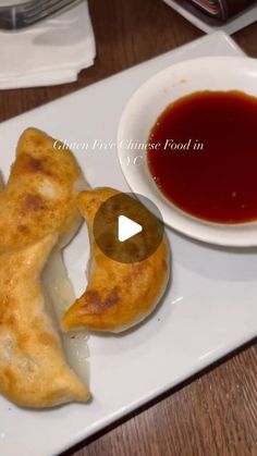 a white plate topped with pastries next to a bowl of sauce