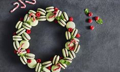 a christmas wreath made out of macaroni and cheese with candy canes on the side