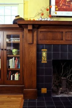 a living room filled with furniture and a fire place in front of a book shelf