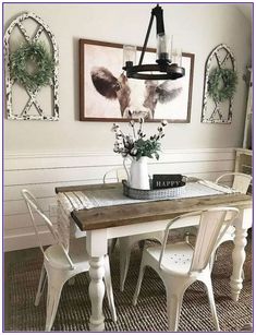 a dining room table with chairs and pictures on the wall