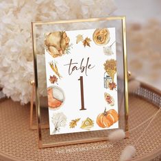 a table number is displayed on a gold frame