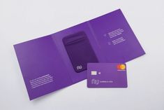 an open purple folder with a credit card next to it