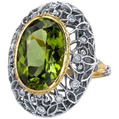 This is a truly beautiful ring, from the size and quality of peridot it features to the exquisite Florentine inspired craftsmanship. The large oval peridot is clear and crystalline, with bright, "Granny Smith" apple green color, set in 18k yellow gold to highlight its beauty. If August is your birth month, peridot is your birthstone. Sparkling round brilliant cut diamonds further adorn the white gold portion of the ring which has been intricately pierced, creating an elegant, regal appearance. Handmade in Italy. Peridot, 16.30 x 11.50 x 7.10mm, 8.85 carats Round brilliant cut diamonds, .24 carat total Ring size 7 Complimentary sizing as needed Granny Smith Apple, Peridot Engagement Rings, Expensive Rings, Peridot Jewelry, Dome Ring, Granny Smith, White Gold Engagement, White Gold Engagement Rings, Domed Ring