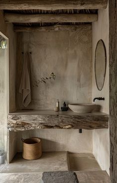 a bathroom with a sink, mirror and towel rack on the wall next to it