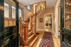 an entry way with stairs and rug on the floor