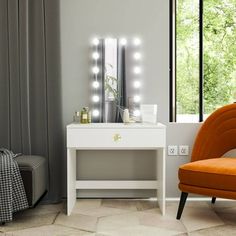 an orange chair sitting in front of a white table with lights on top of it