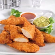 fried food on a white plate with dipping sauce