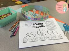 the sound crown is next to some crayons and pens on a table with other items