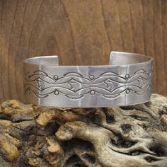 Vintage sterling silver cuff bracelet with intricate stamped designs. The inside measurement of the bracelet is 5 3/4" and then there is an additional 1" gap. This piece is 3/4" wide and weighs 32.7 grams. It is not stamped with the artist's hallmark but it is stamped "sterling". Thank you for looking at this bracelet, please message us with any questions. Southwestern Stamped 925 Cuff Bangle Bracelet, Western Silver Cuff Bracelet With Concho, Western Silver Concho Cuff Bracelet, Western Style Stamped Cuff Bracelet, Silver Southwestern Stamped Cuff Bracelet, Southwestern Silver Stamped Cuff Bracelet, Southwestern Silver Engraved Cuff Bracelet, Southwestern Sterling Silver Stamped Bangle Bracelet, Southwestern Stamped Silver Cuff Bracelet