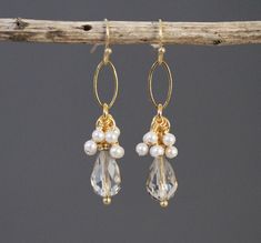 Champagne-colored faceted glass teardrops are embellished with tiny hand-wrapped glass pearls and hung from a gold-plated oval ring.  Earrings dangle about 1.25 inches from bottom of gold-plated fish hook ear wires.  Beautiful as a bridal or formal accessory. Teardrop Faceted Earrings For Wedding, Faceted Teardrop Earrings For Weddings, Wedding Teardrop Faceted Earrings, Teardrop Faceted Crystal Earrings For Weddings, Faceted Teardrop Crystal Earrings For Wedding, Wedding Teardrop Faceted Crystal Earrings, Wedding Drop Earrings With Faceted Beads, Wedding Crystal Dangle Earrings With Faceted Beads, Faceted Crystal Drop Earrings For Wedding