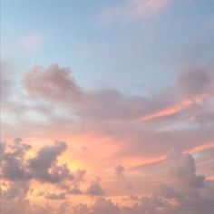 an airplane flying in the sky at sunset