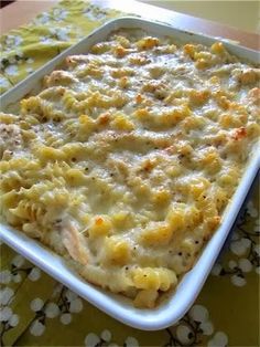 a casserole dish filled with macaroni and cheese sitting on a table