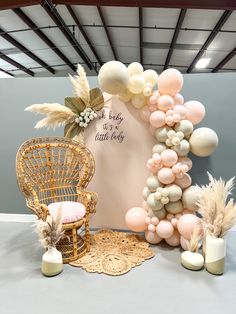 a balloon arch is set up in front of a chair