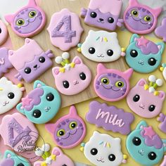 decorated cookies are arranged in the shape of cats and kittens with numbers on them