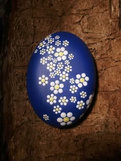 a painted egg sitting on top of a wooden table