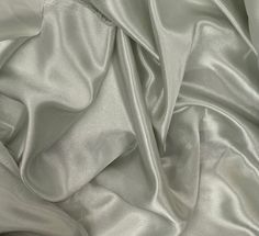 a close up view of a silver satin fabric