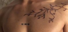 a close up of a person's chest with leaves on it and the word love written in black ink