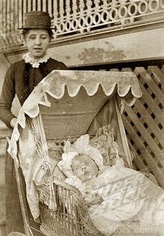 an old black and white photo of a baby in a stroller