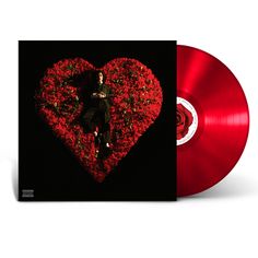 a red vinyl record with a heart shaped arrangement in the shape of a person laying on it