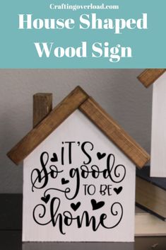 a house shaped wood sign that says it's good to be home