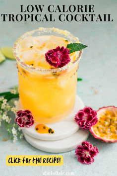 a tropical cocktail garnished with flowers and limes on a white plate text reads low calorie tropical cocktail click for the recipe