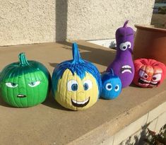 three pumpkins with faces painted on them