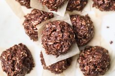 chocolate and oatmeal cookies sitting on top of each other in paper wrappers