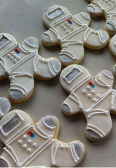 decorated cookies with white frosting on a table