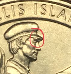 a close up of a coin with the word ellis island circled by a red circle