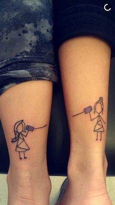 two people with matching tattoos on their legs