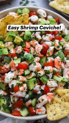 a bowl full of shrimp salad with tortilla chips