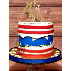 an american flag cake with gold stars on top and red white and blue frosting