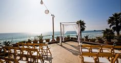 an outdoor ceremony set up on the beach